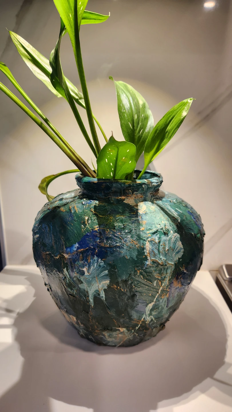 Upcycled art piece planter with plant