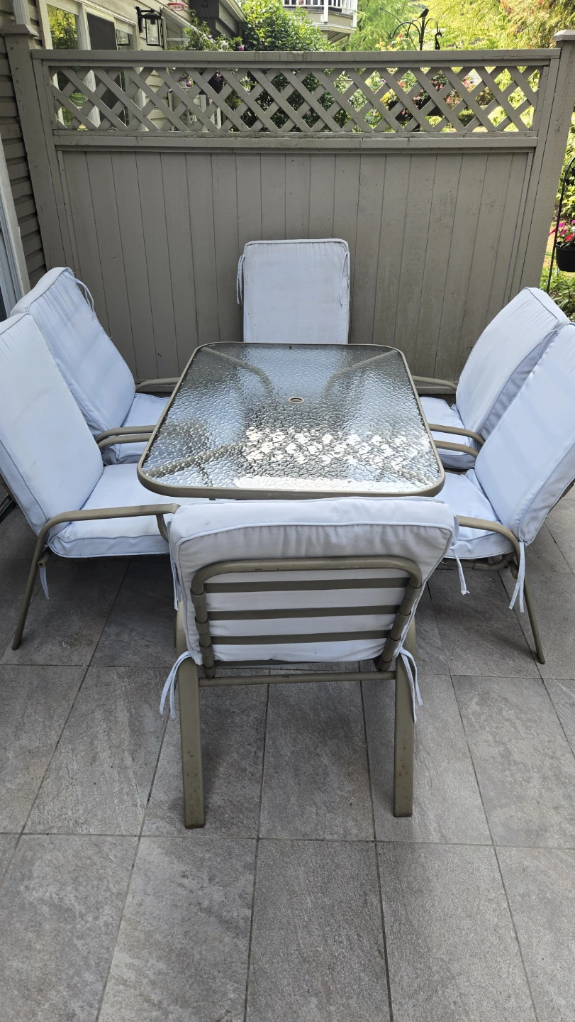 Glass top patio table with six chairs