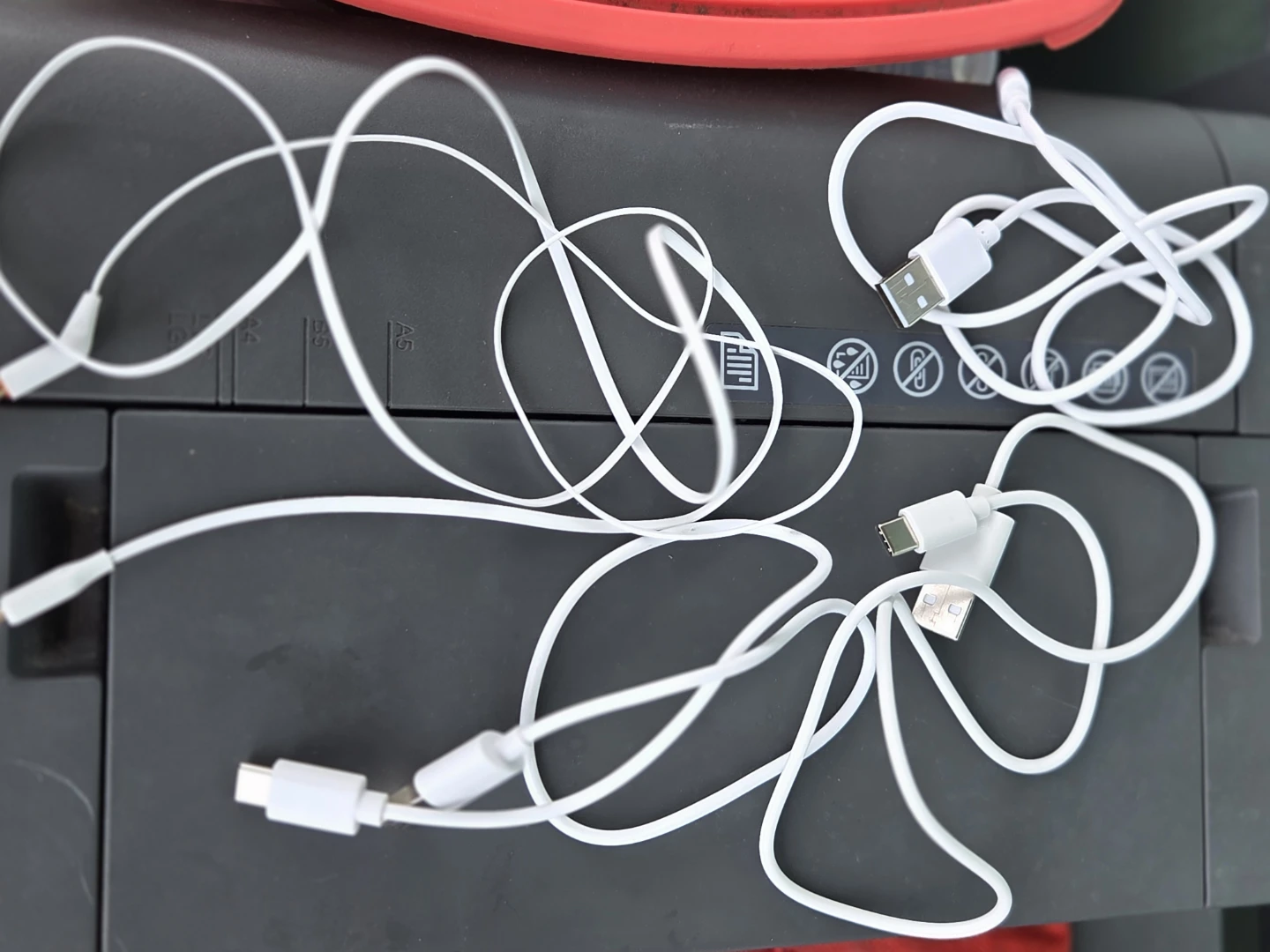 Assorted White Charging Cables and Earbuds