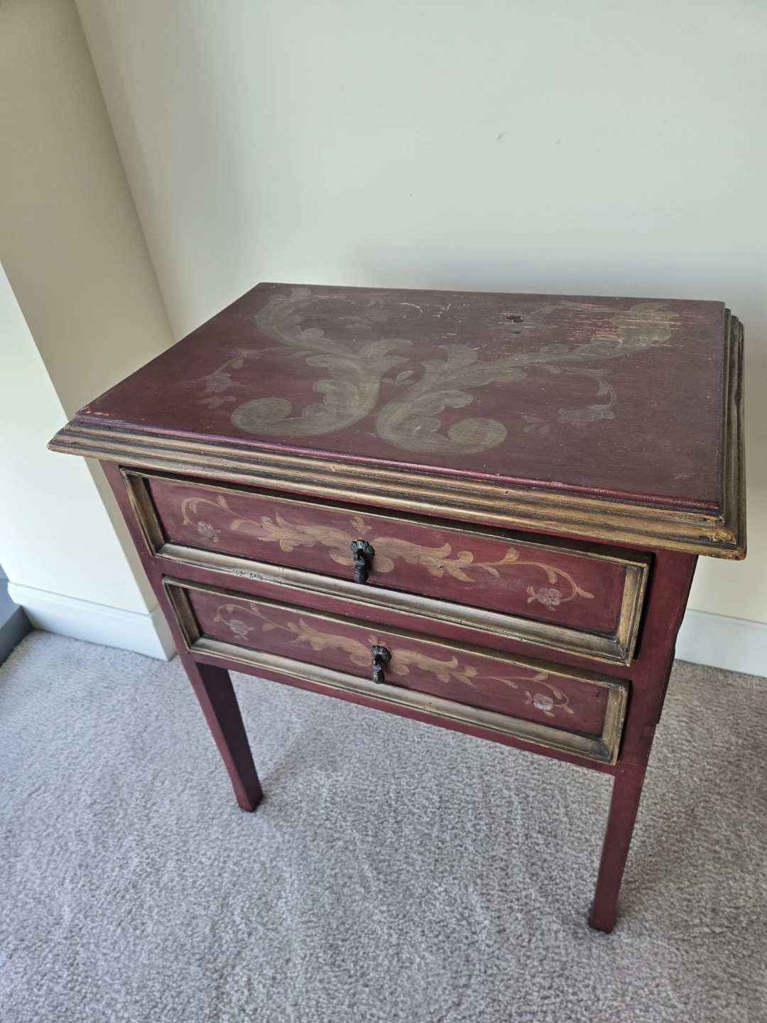 Red Accent Table with Floral Design