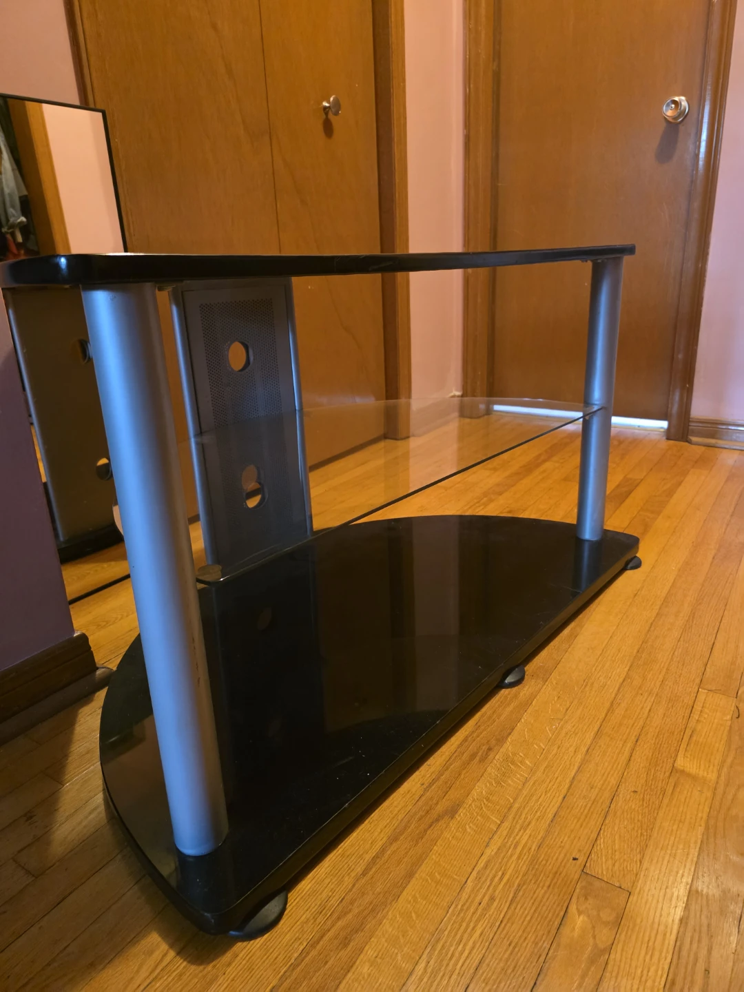 Black glass TV stand with silver legs