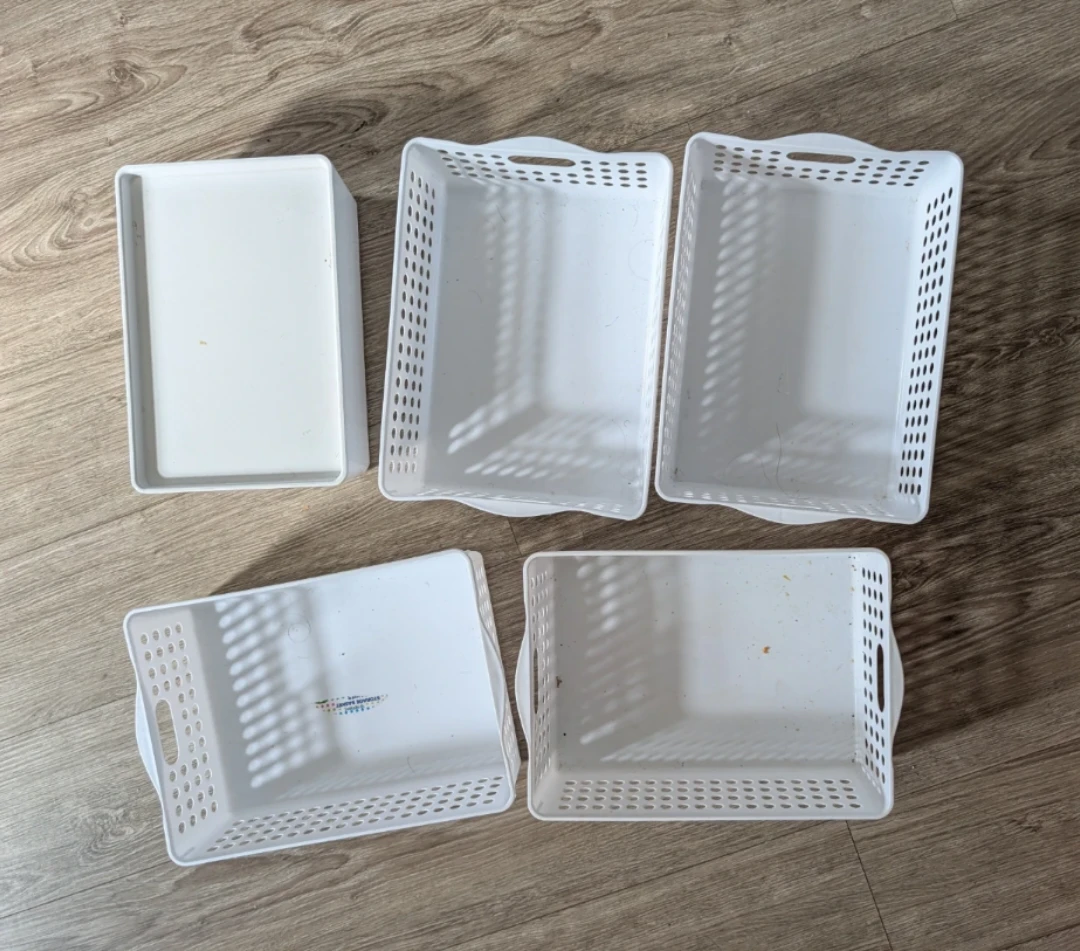 Four plastic  Storage Baskets annd one Ikea bastek with lid.