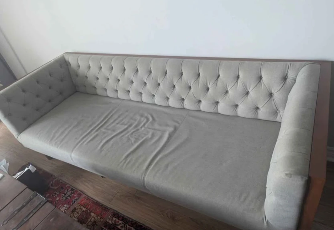 Tufted grey sofa with walnut frame
