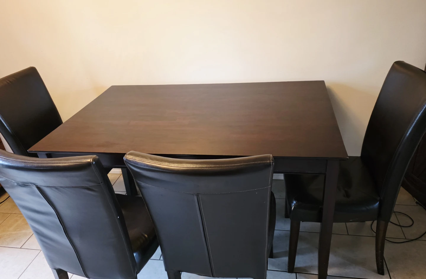 Dark brown wooden dining table with 4 chairs, In Millwoods.