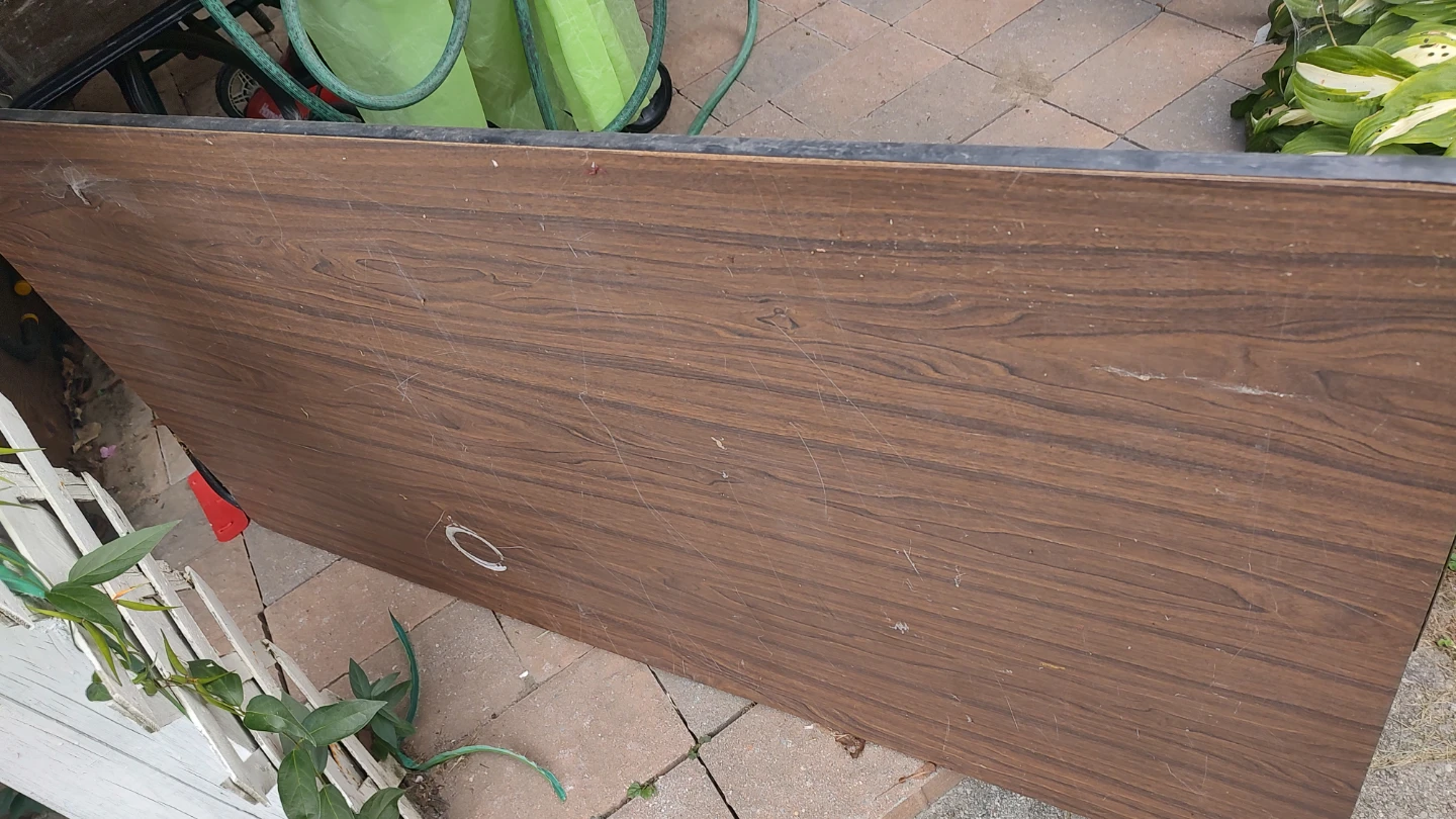 Folding table with wood-grain finish