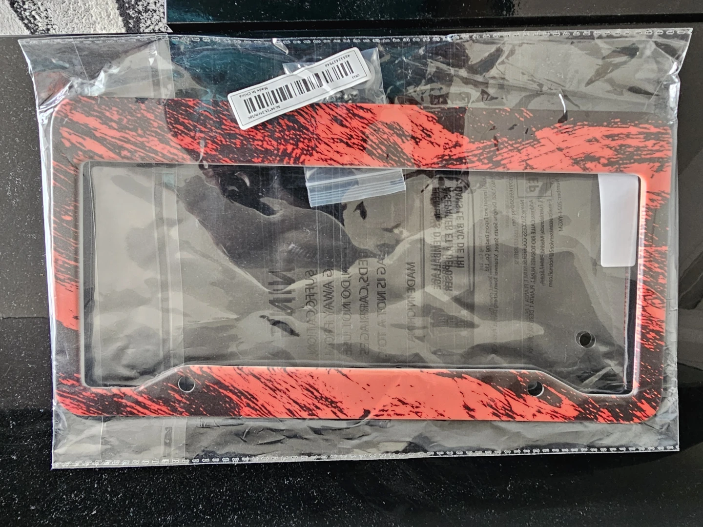 Red and black license plate frame