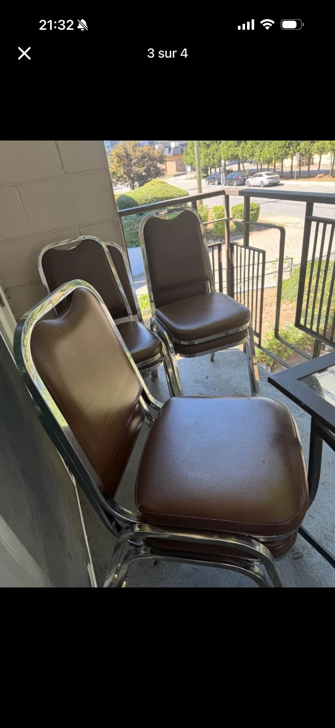 Three brown vinyl and chrome stackable chairs