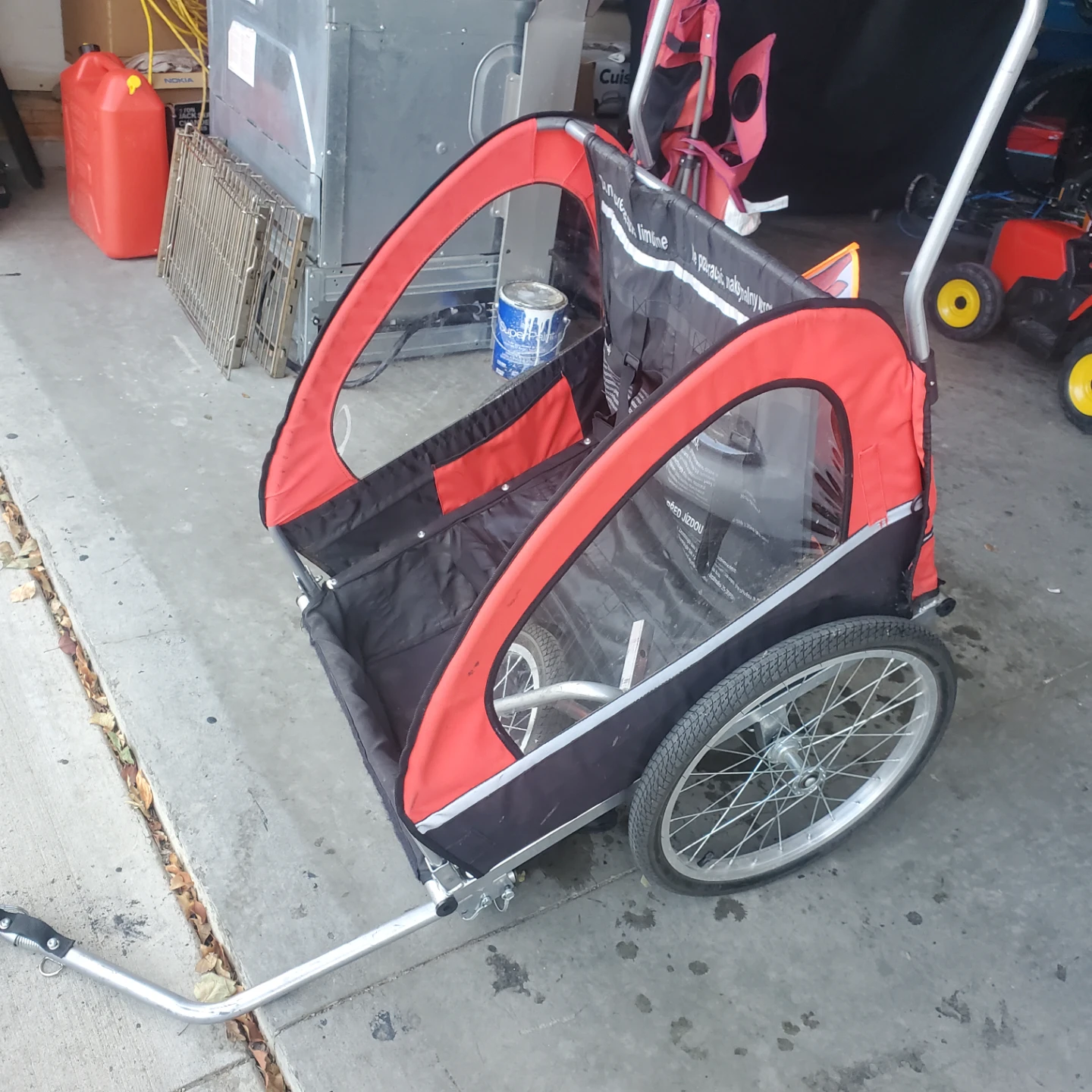 Red and black bike trailer for children