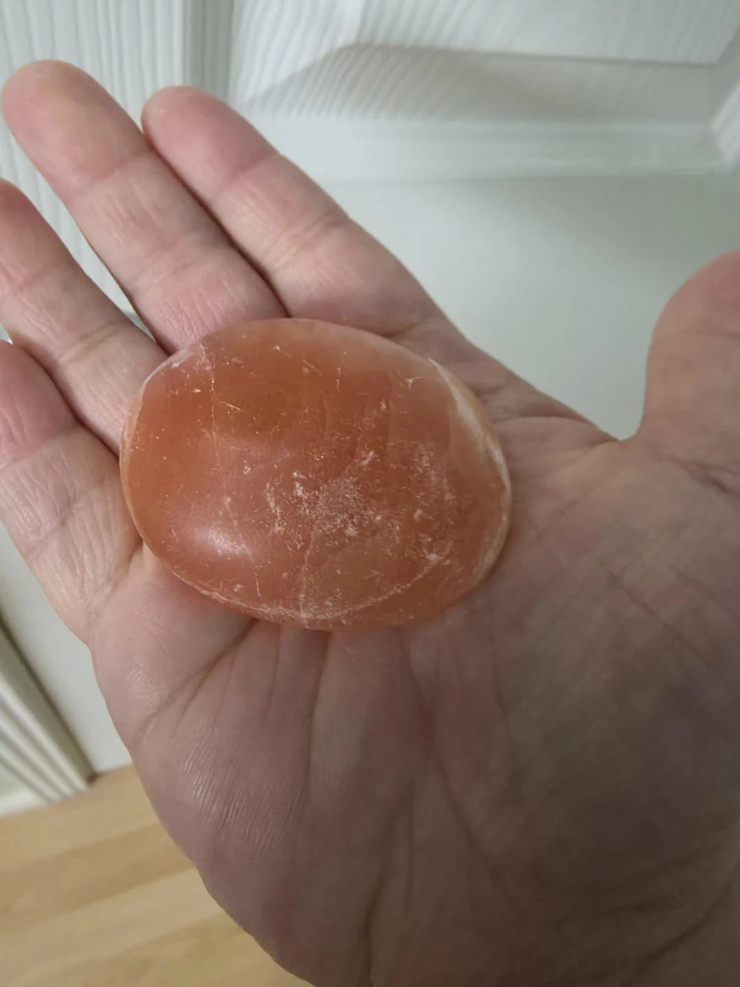 Polished Orange Calcite Palm Stone - photo 2