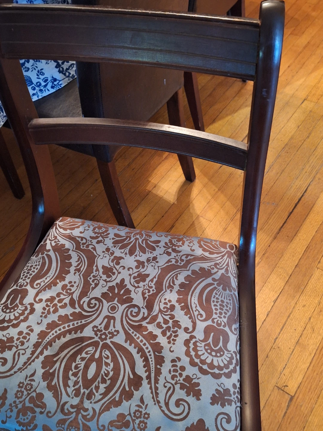 Wooden dining chair with patterned upholstery