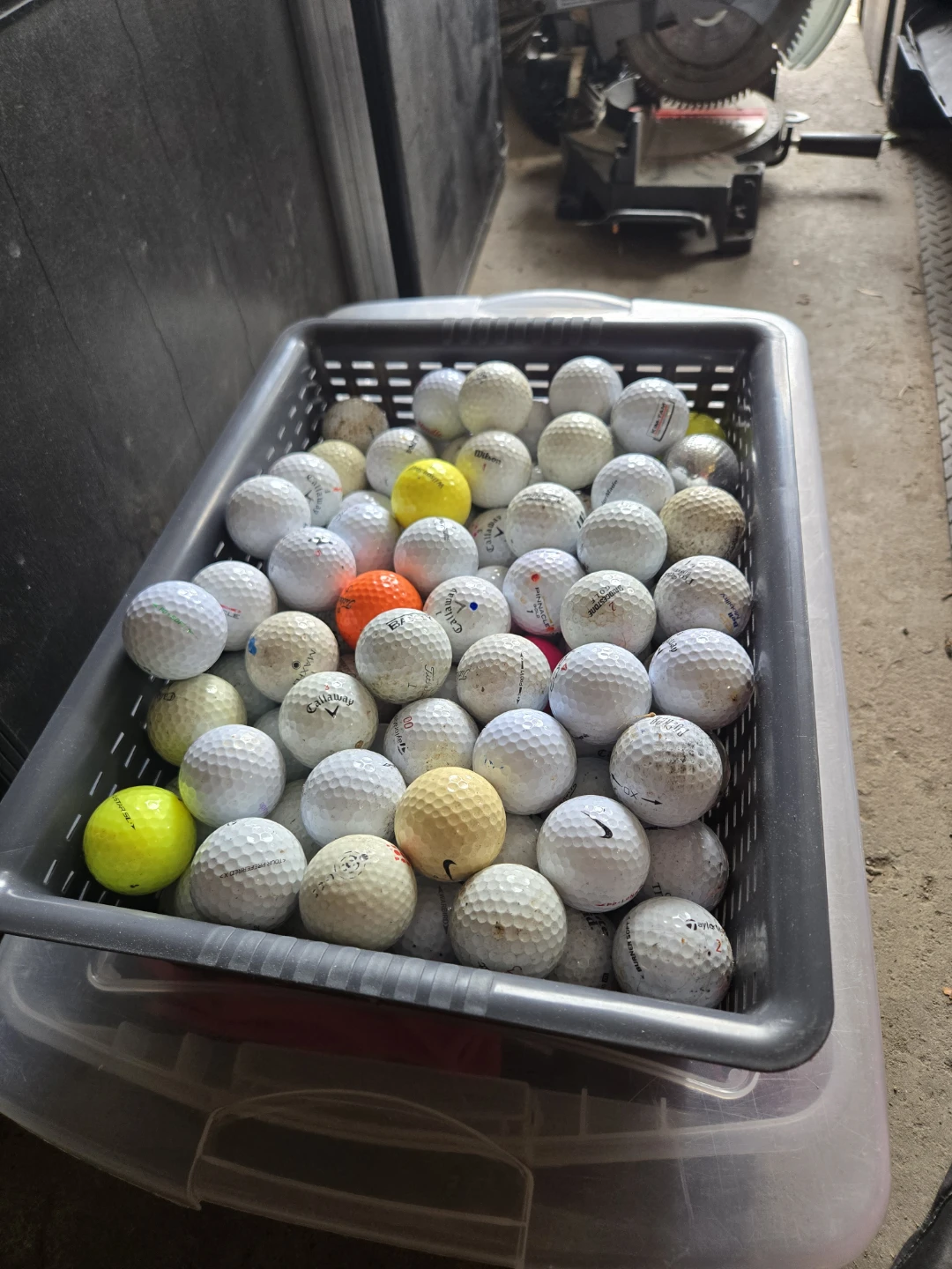 128 Assorted Golf Balls in Storage Bin