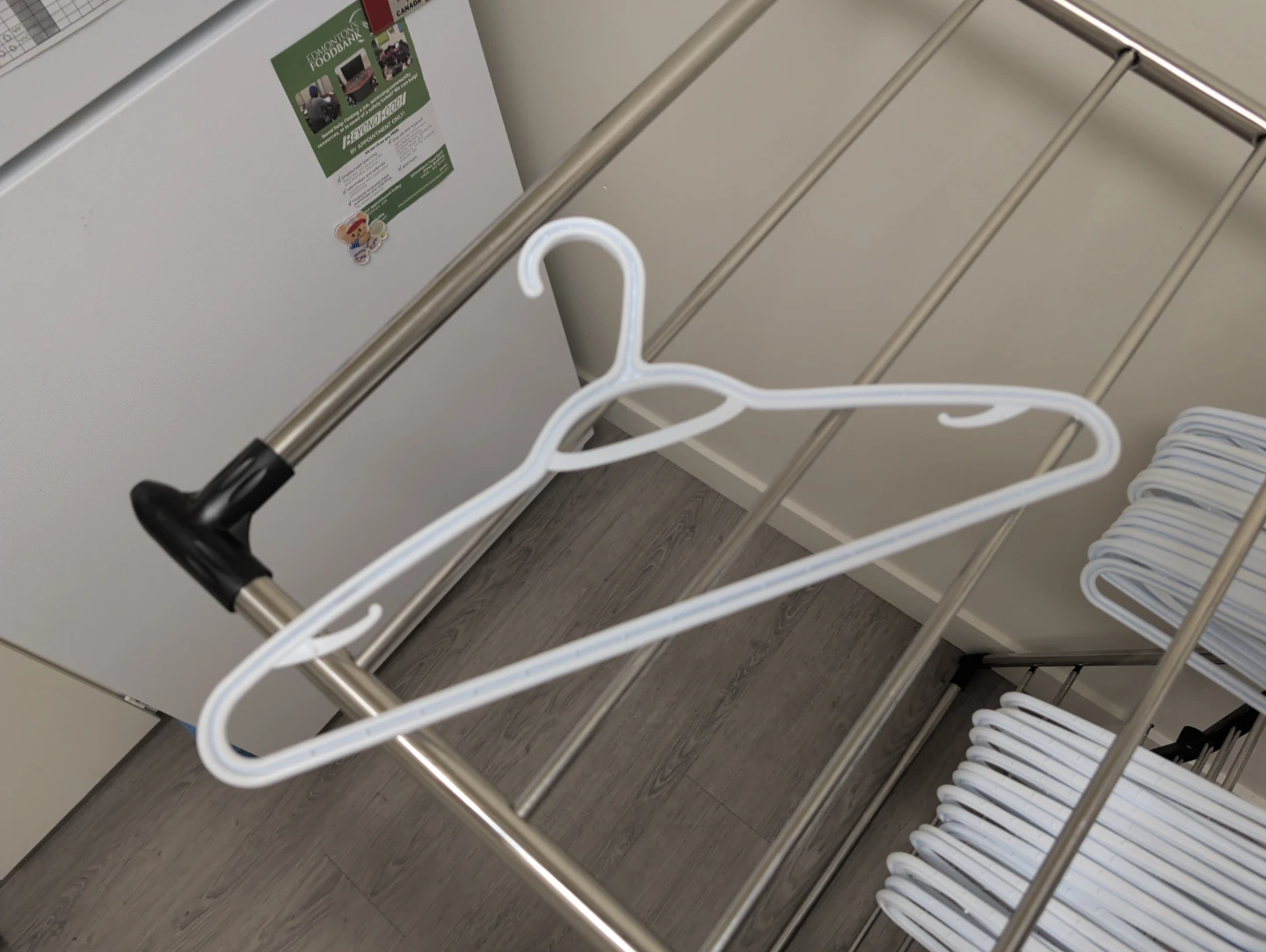 Set of white plastic clothing hangers