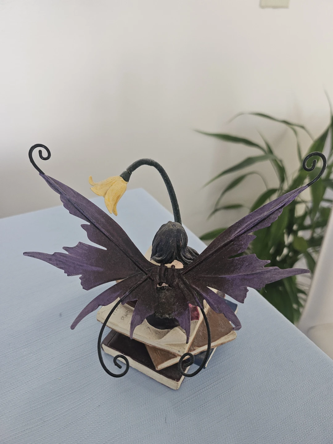 Fairy Figurine Sitting on Books with light. - photo 2
