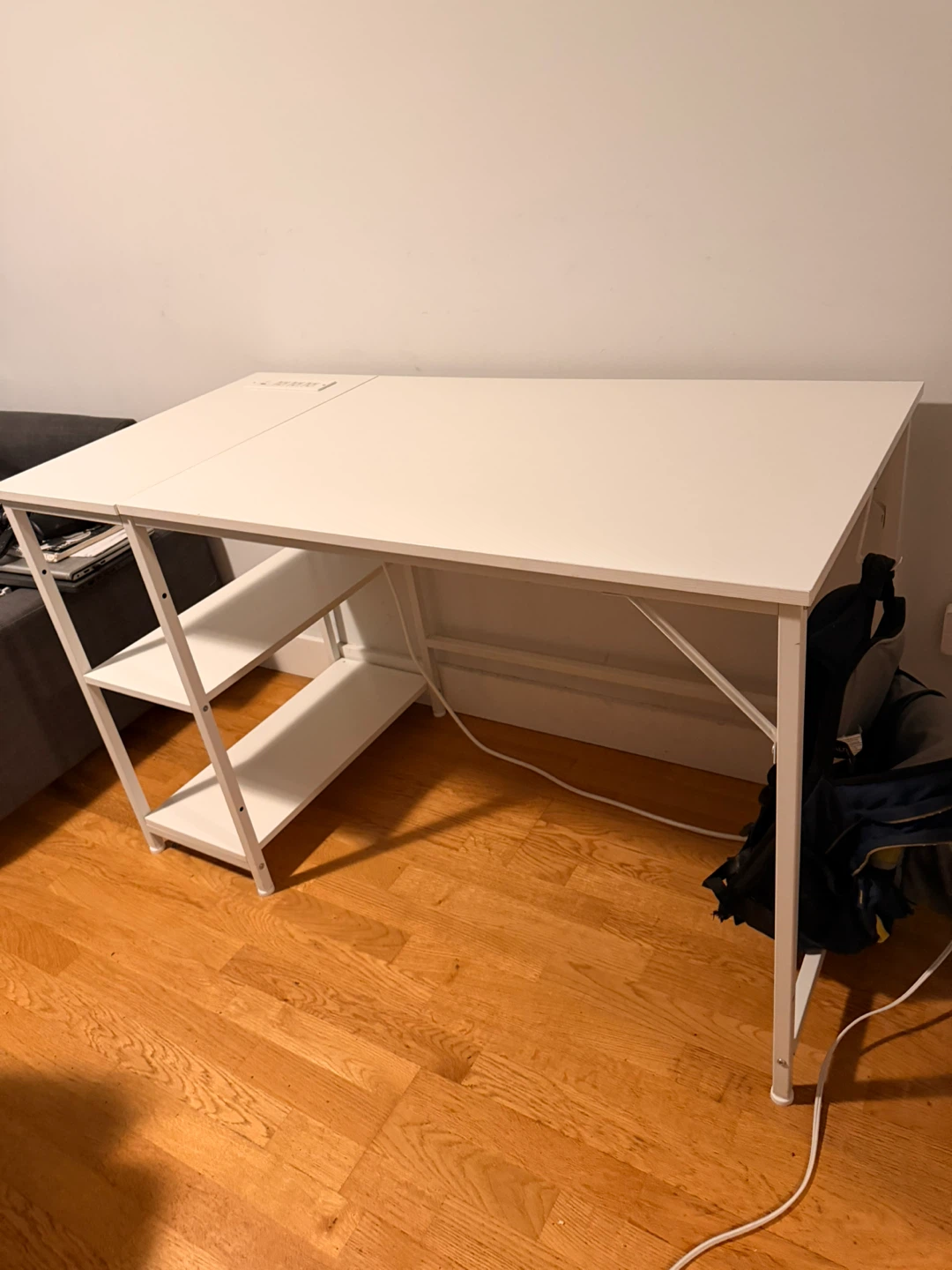 White desk with built-in power outlets and storage shelves