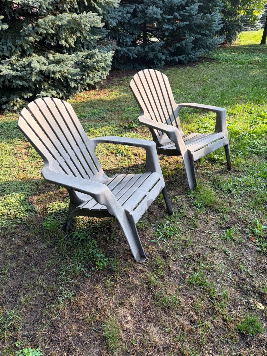 Two Plastic Adirondack Chairs