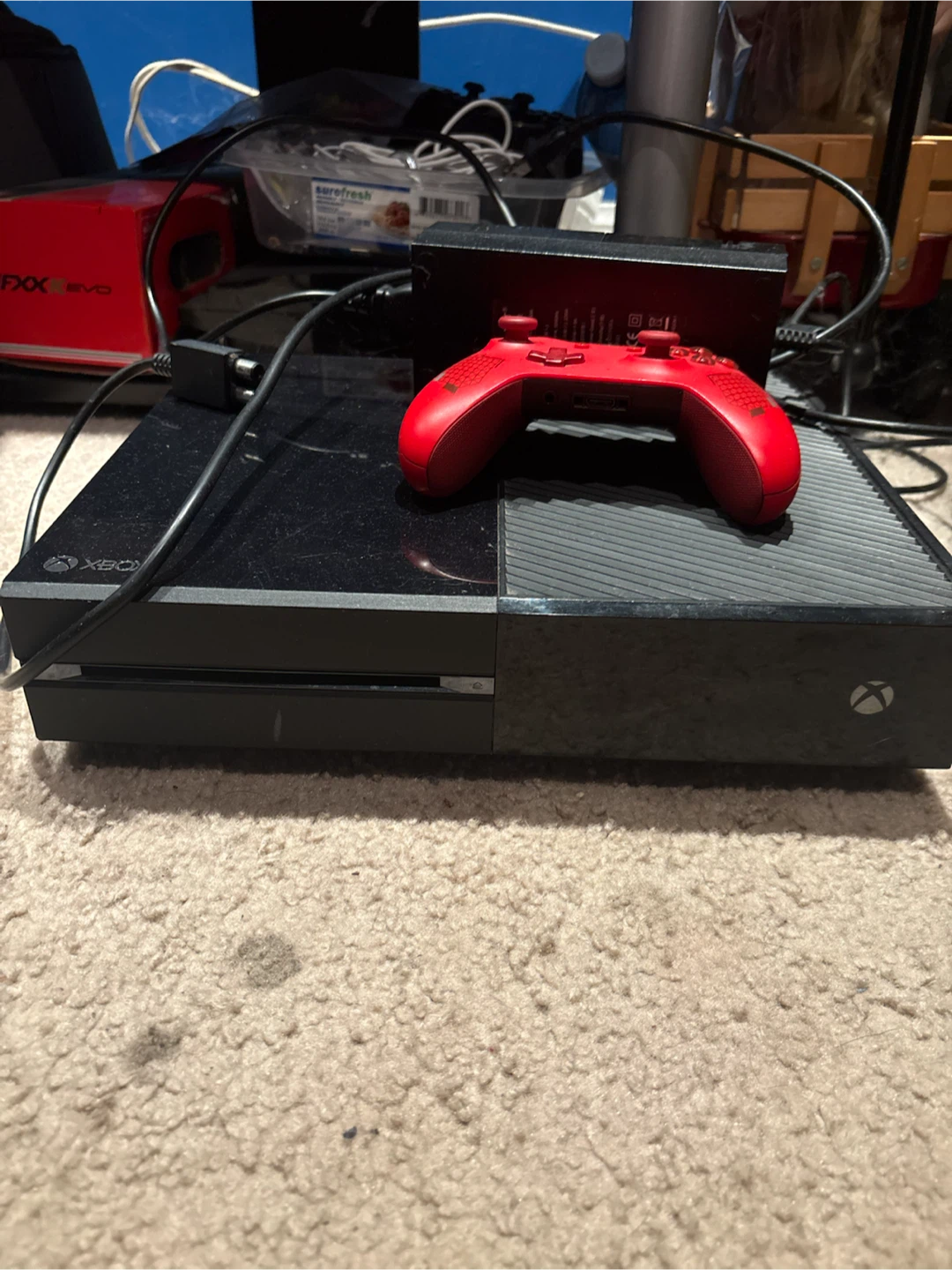 Xbox One console with red controller