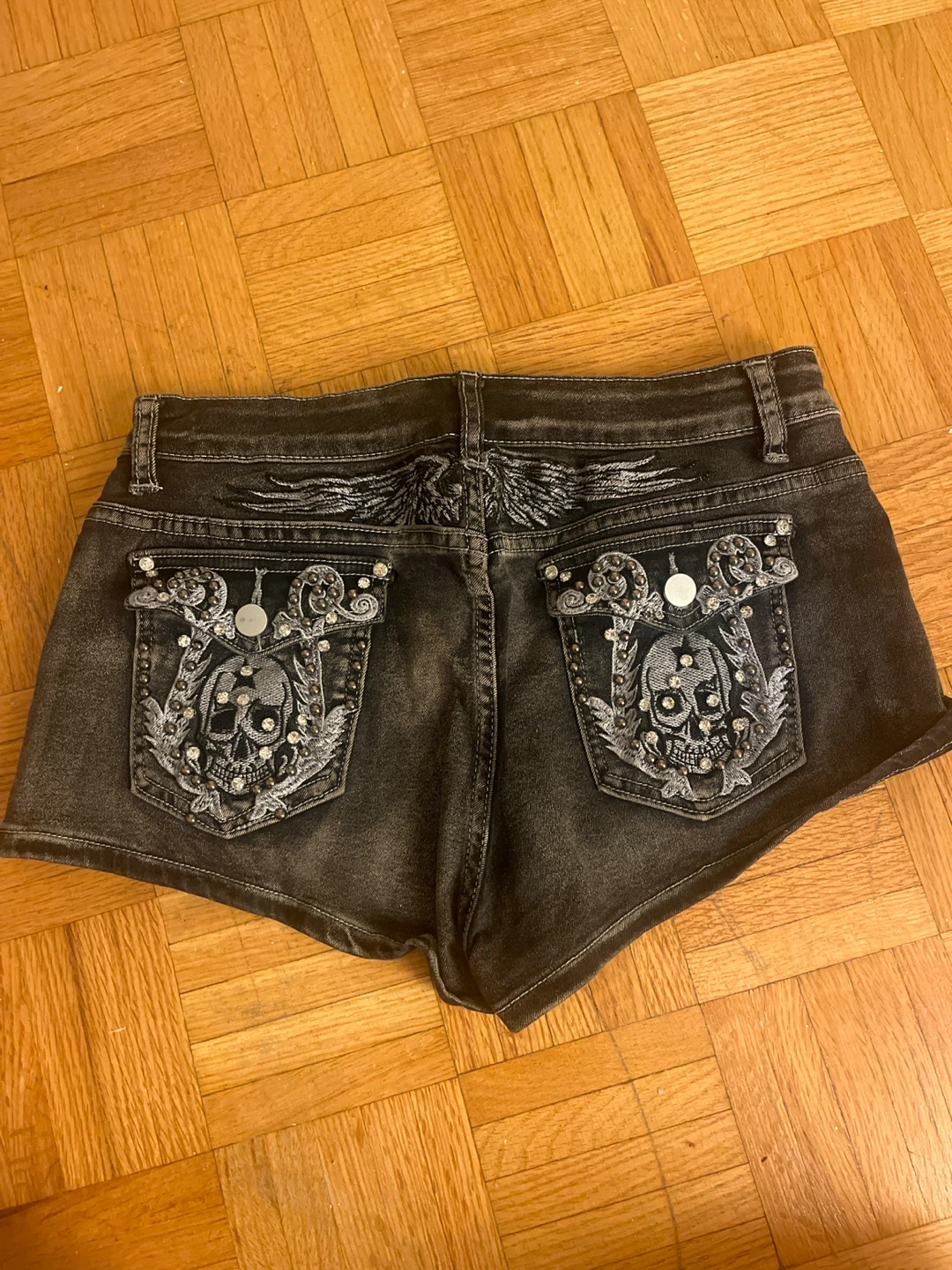 Distressed Black Denim Shorts with Skull Embellishments