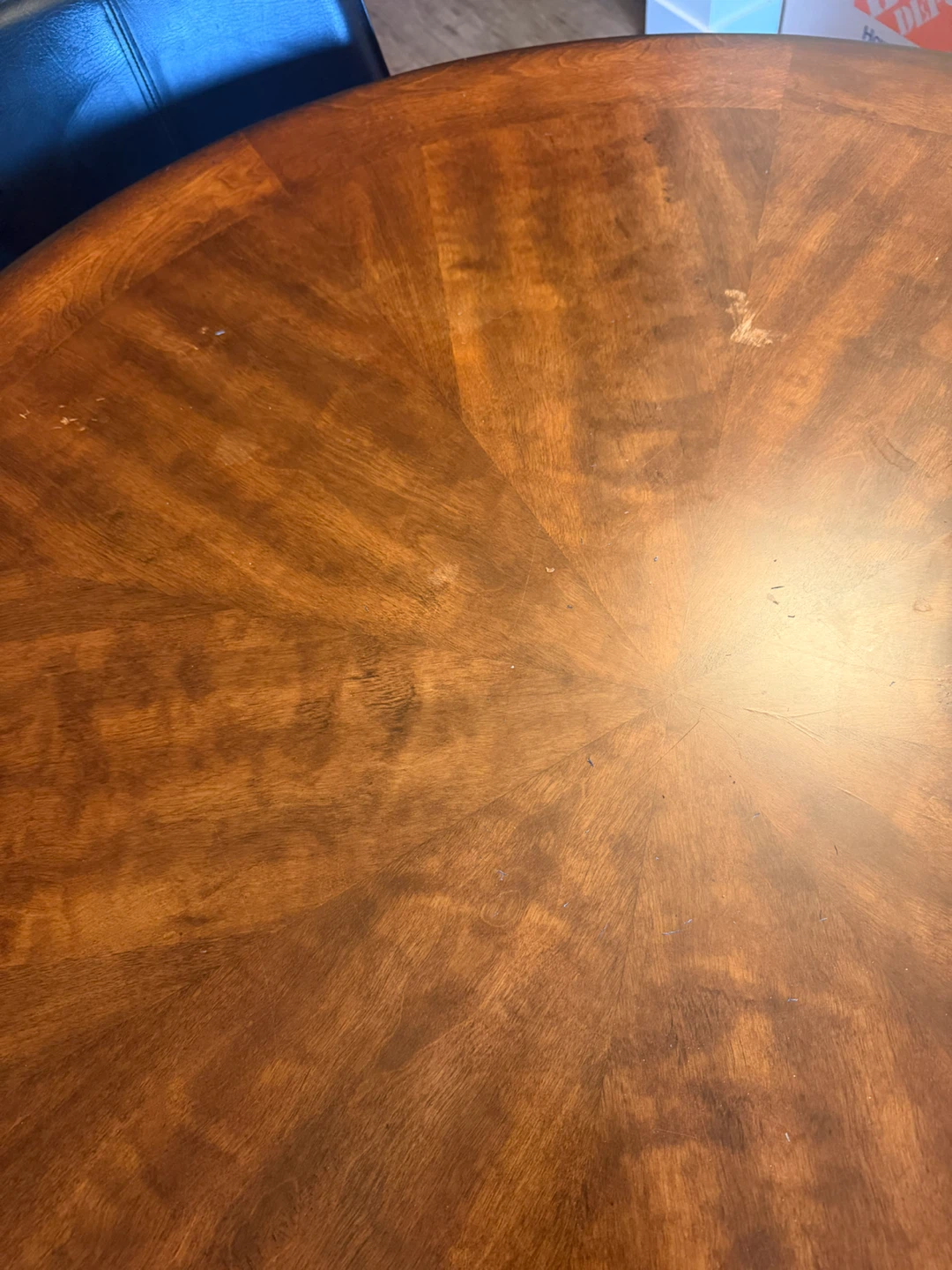 Round cherry wooden dining table with four black chairs - photo 3