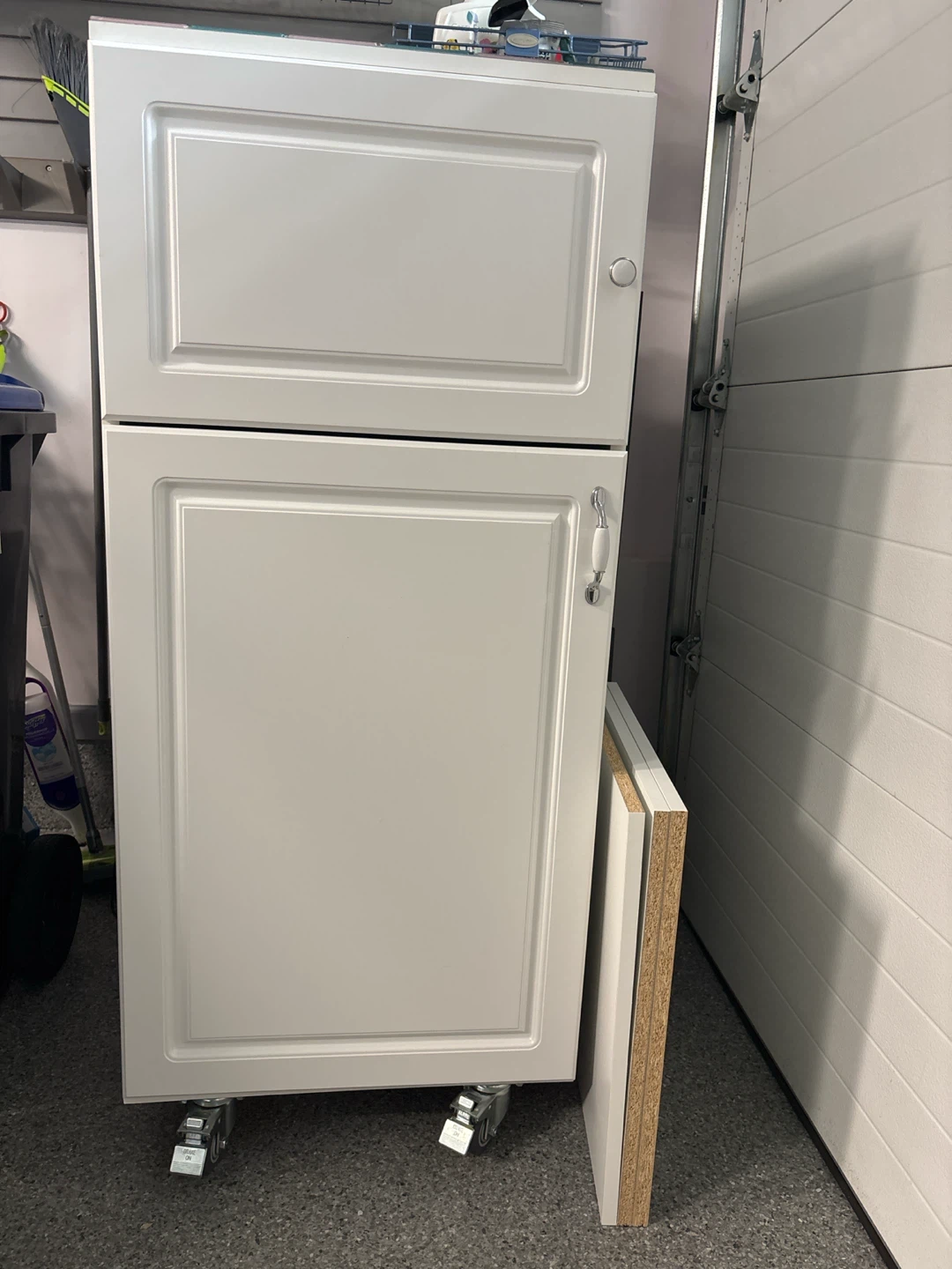 White rolling storage cabinet with two doors