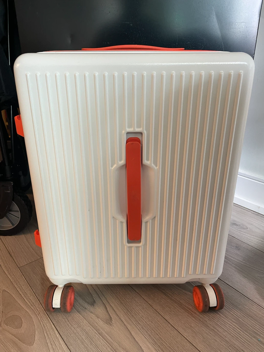 White and orange hardshell carry-on suitcase