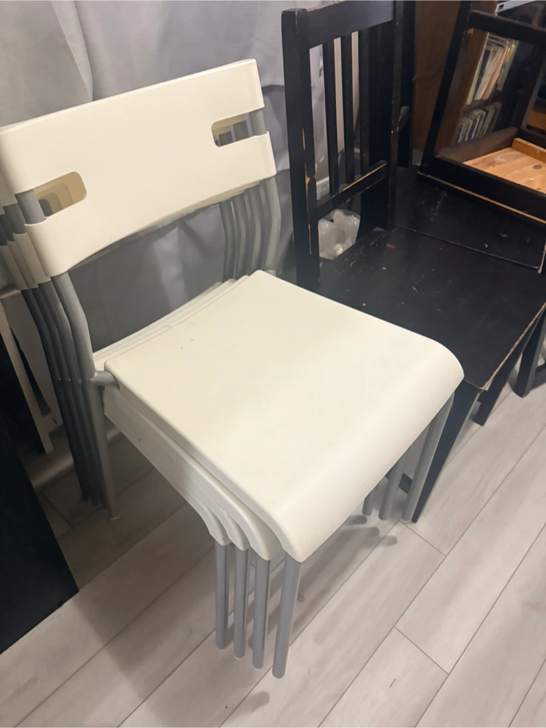 2 sets of chairs, 4 white plastic and 3 black wooden