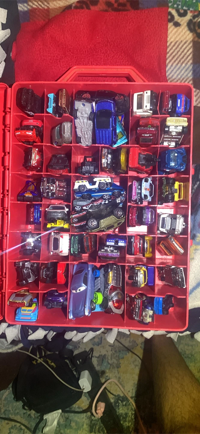 Large collection of Hot Wheels toy cars with red carry case