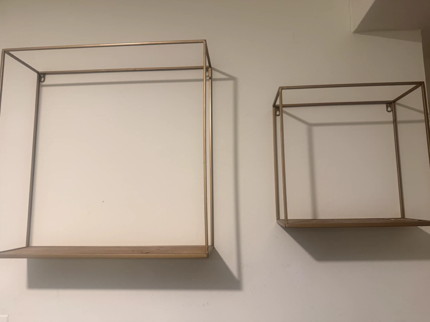 Set of two gold and wood wall shelves