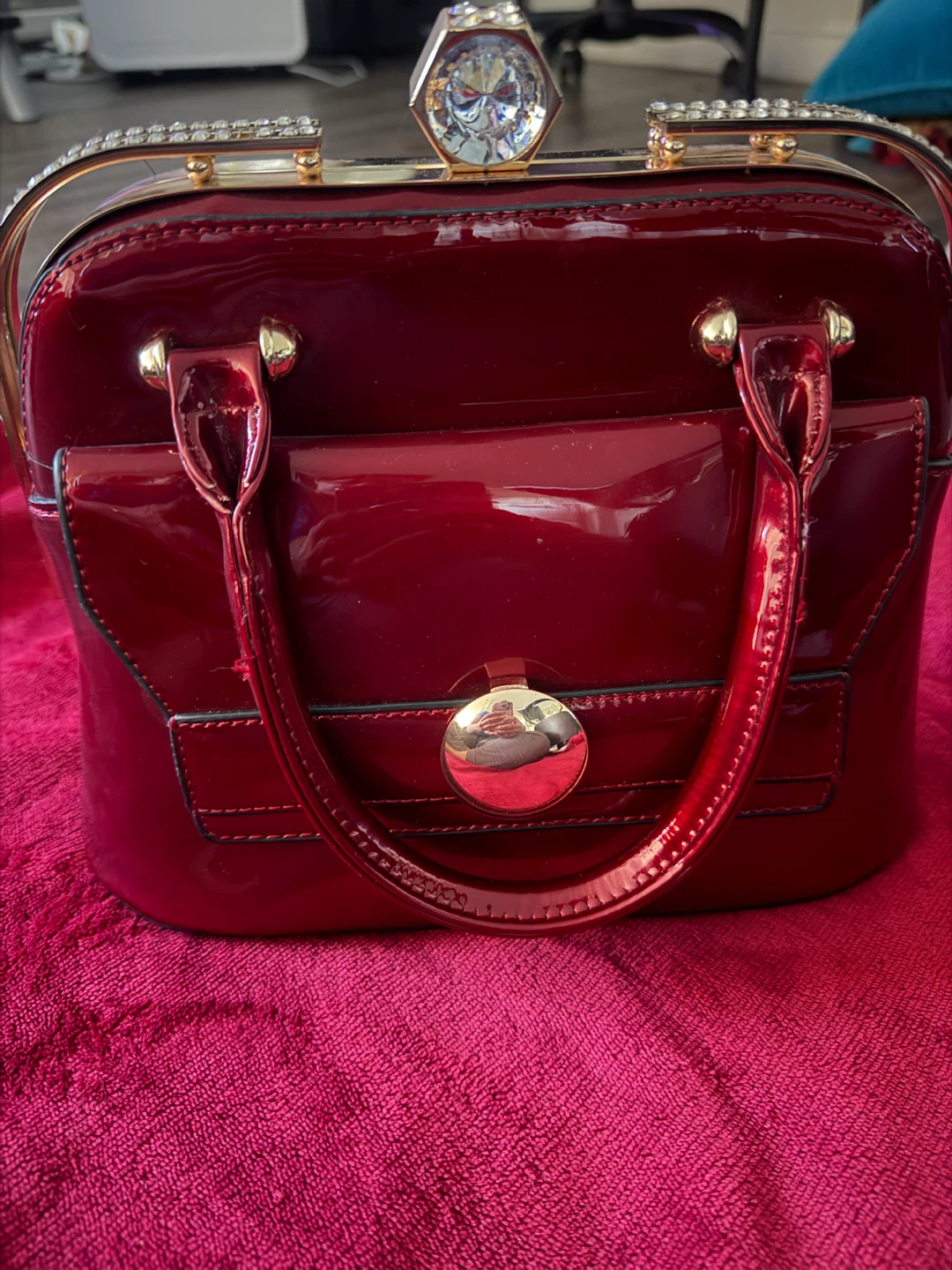 Red patent leather handbag with rhinestone accents