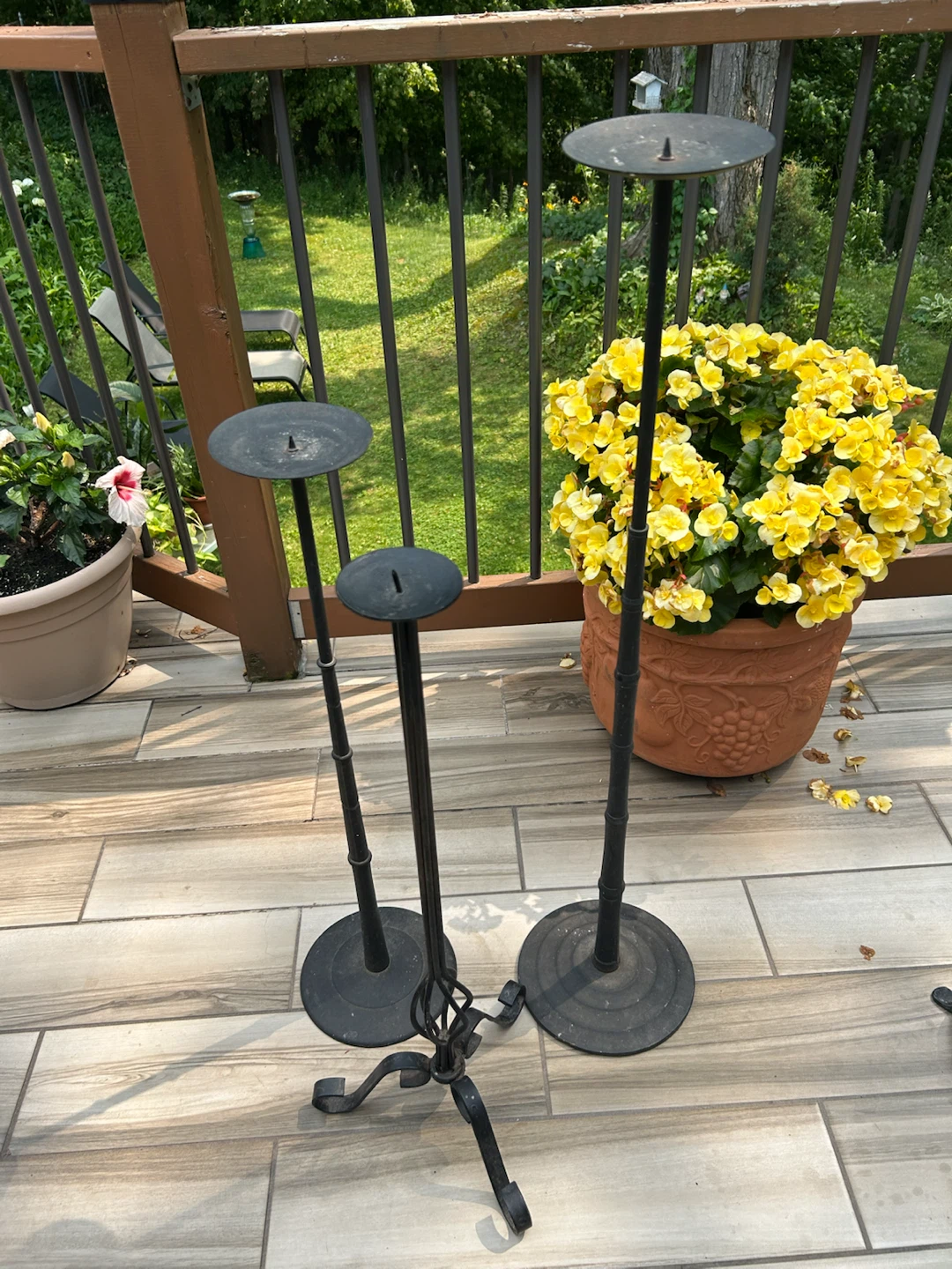 Three wrought iron floor candlesticks
