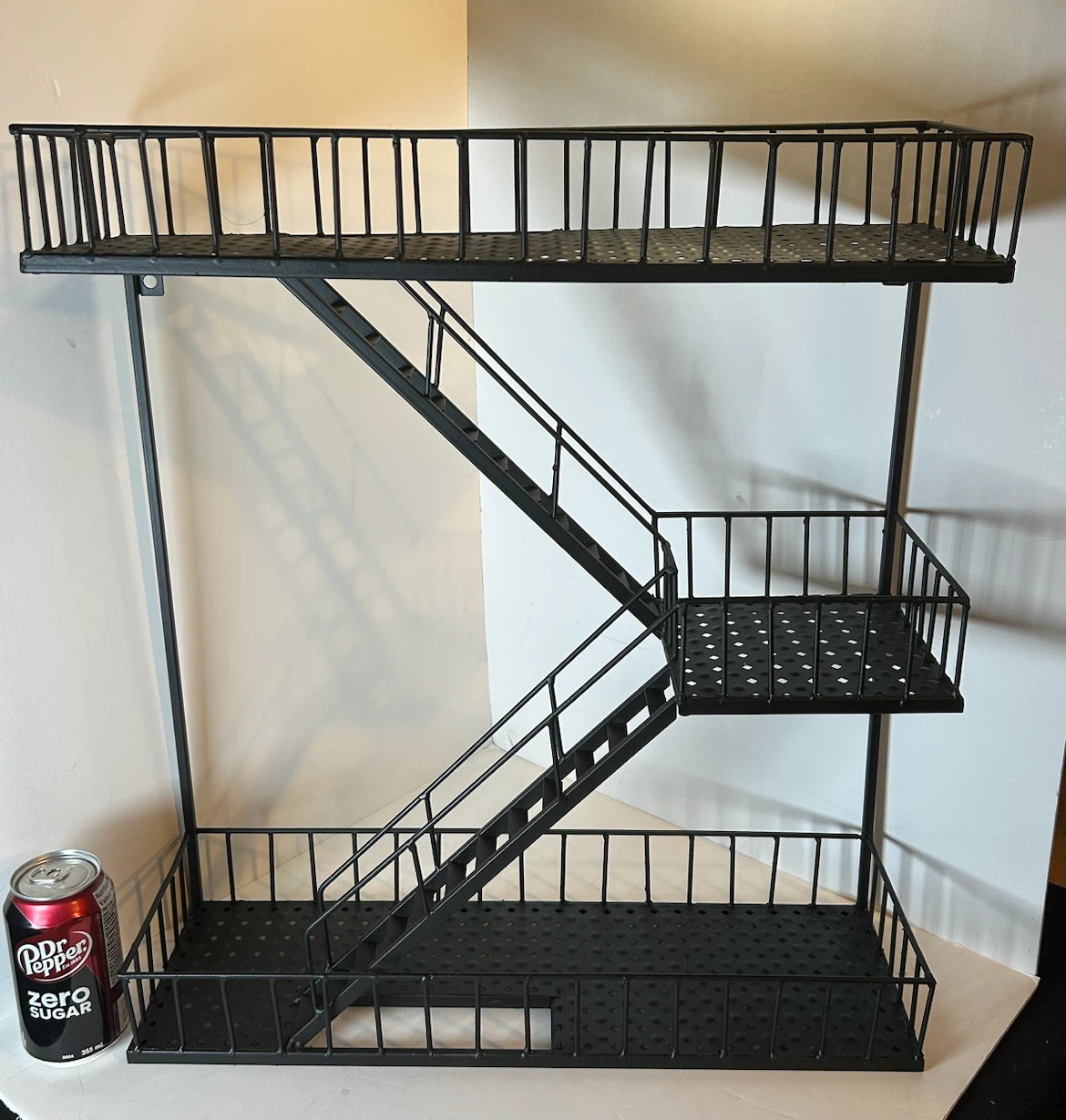 Metal fire escape wall shelf