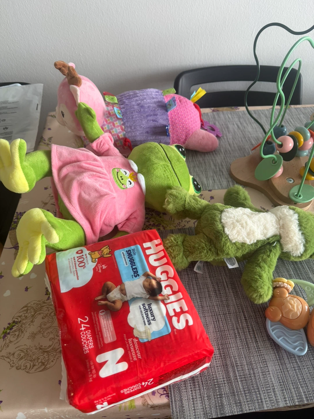 Assorted Baby Toys and Huggies Diapers