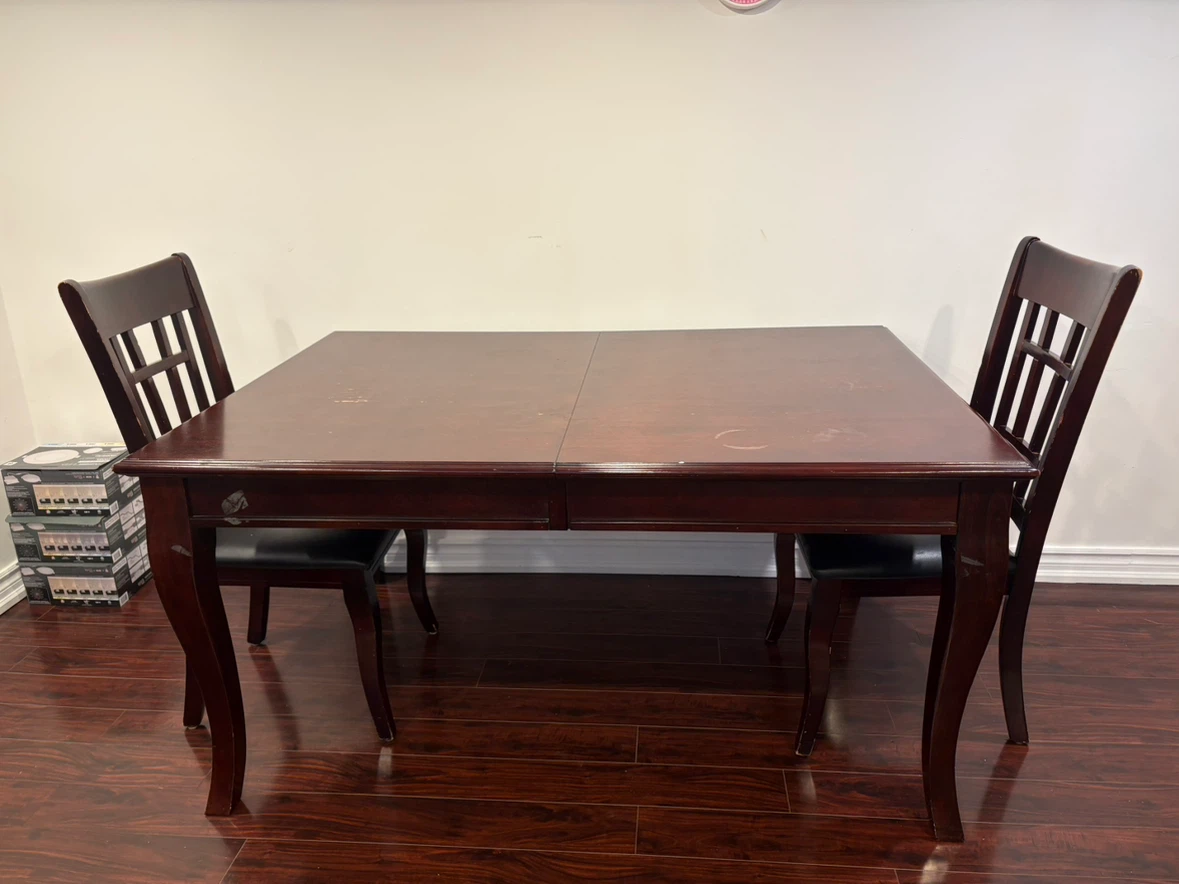 Dark wood dining table with 4 chairs
