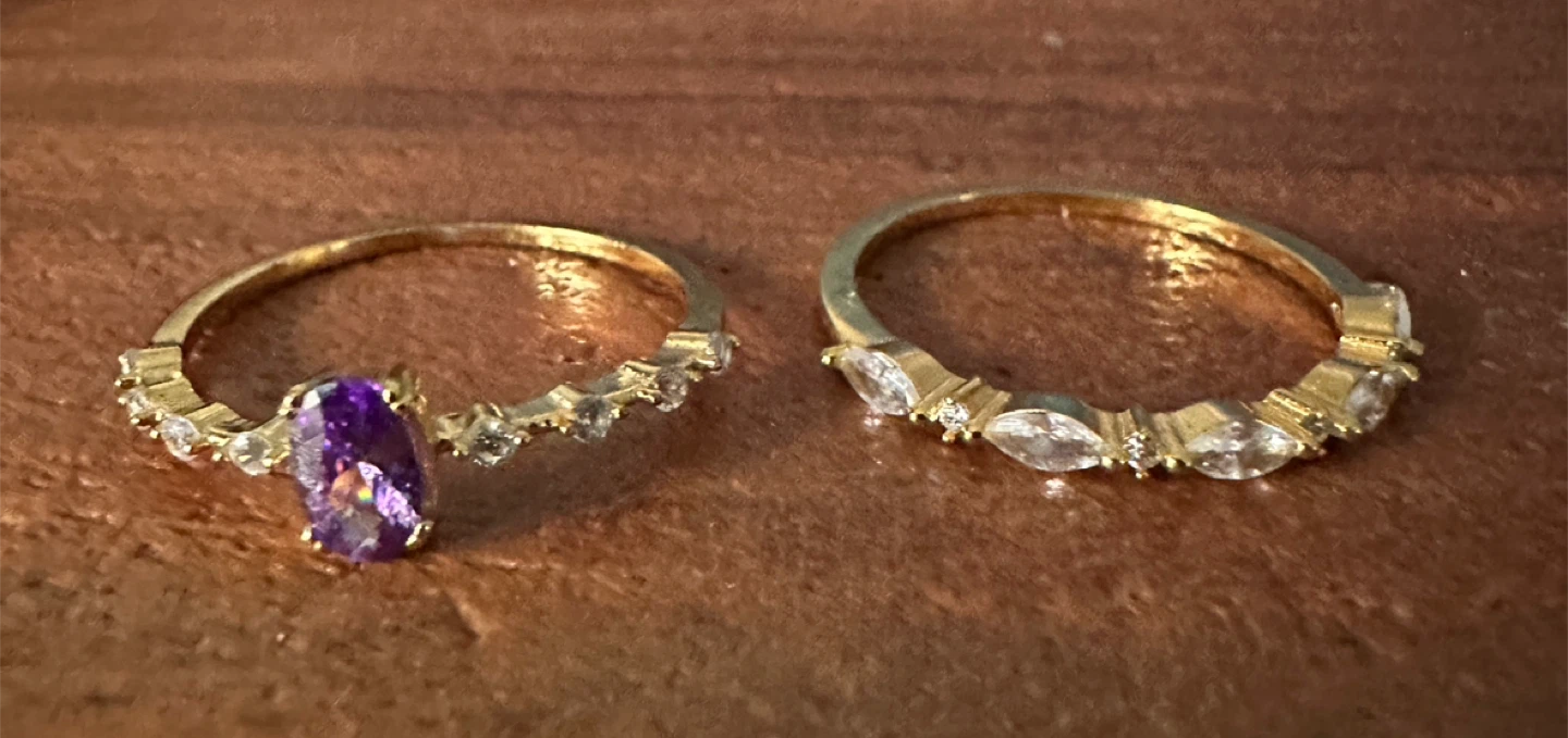 Gold-tone rings with purple and clear stones