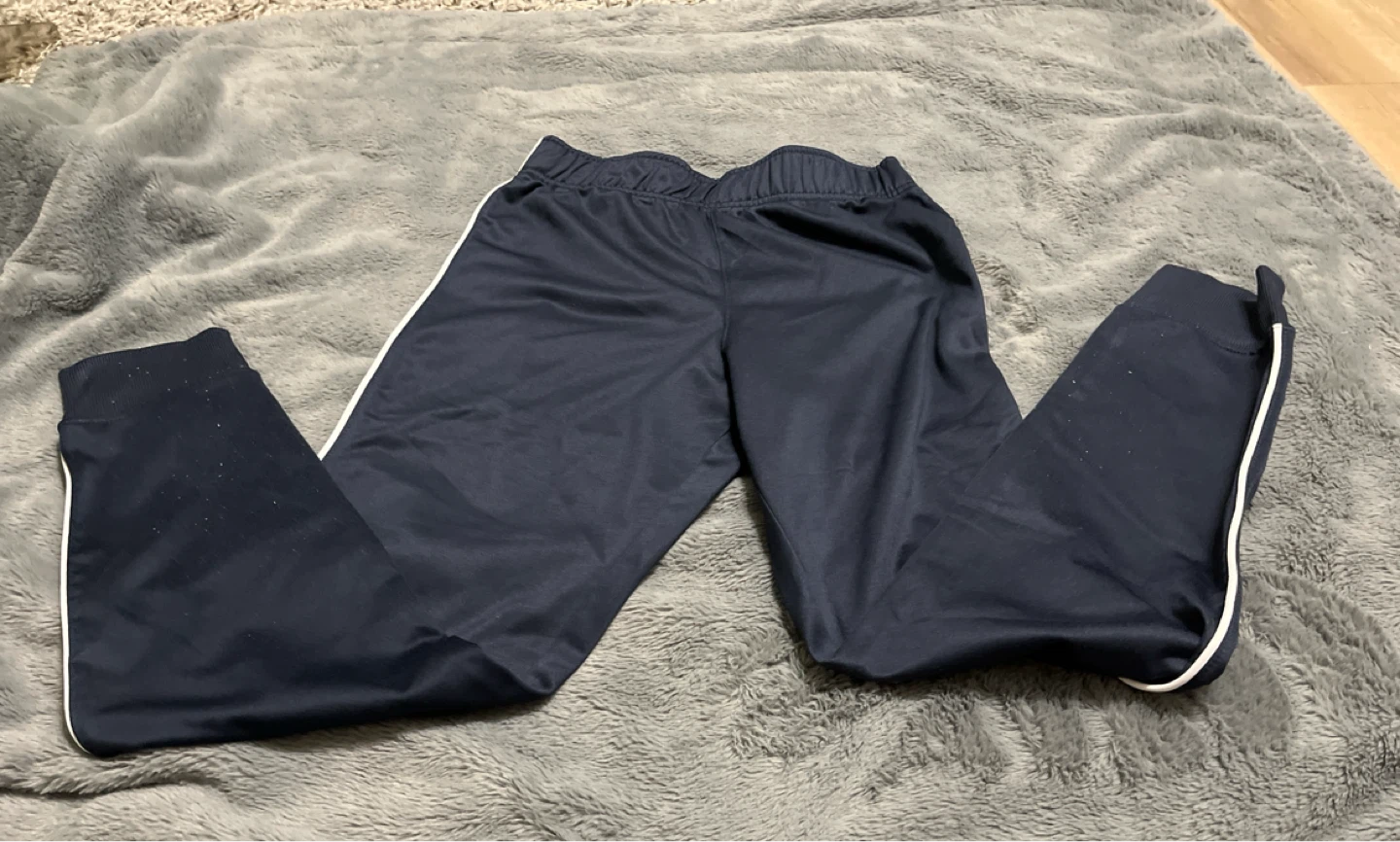 Navy blue track pants with white stripes