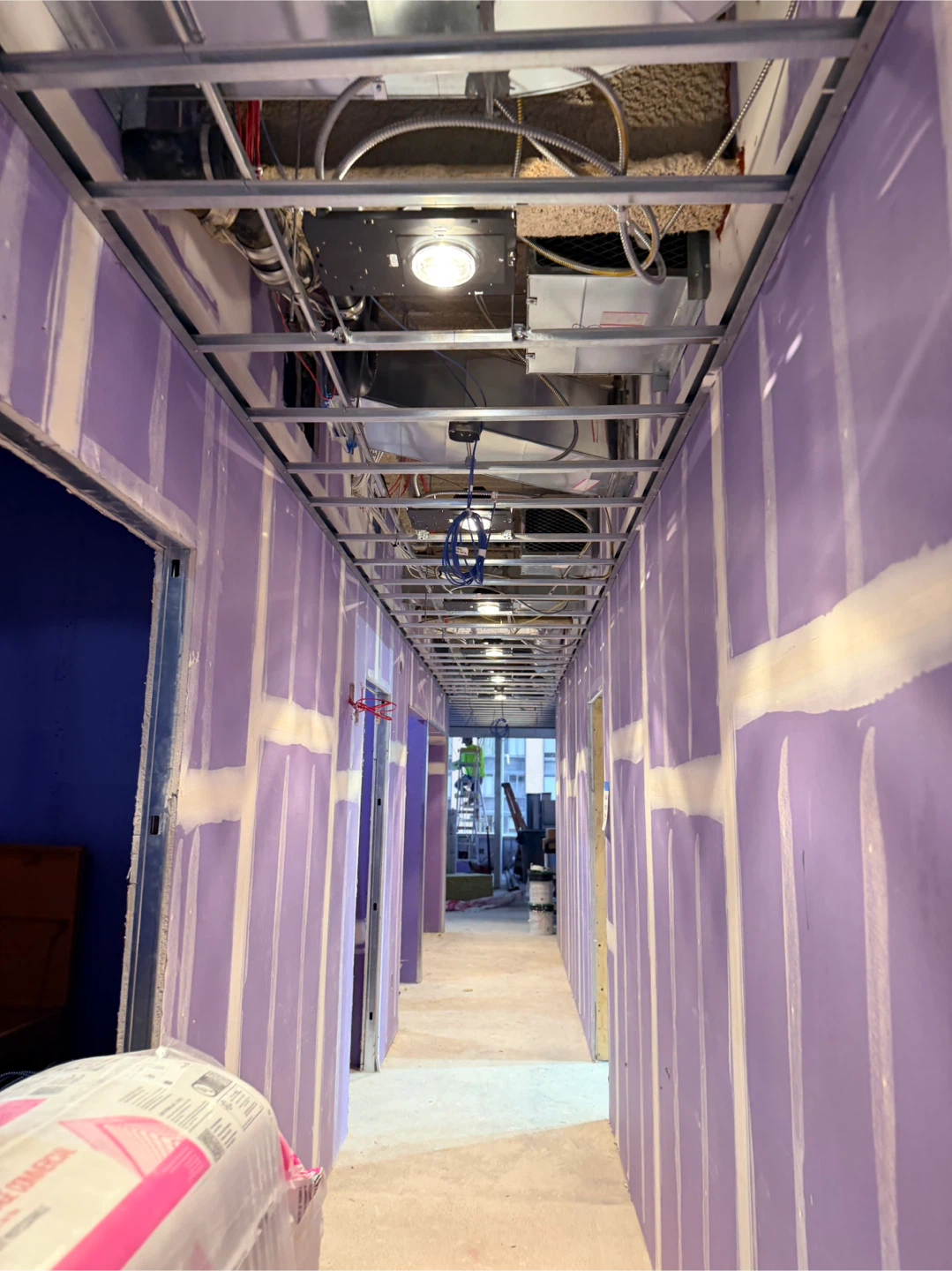 Construction Site Hallway with Drywall and Exposed Utilities - photo 3