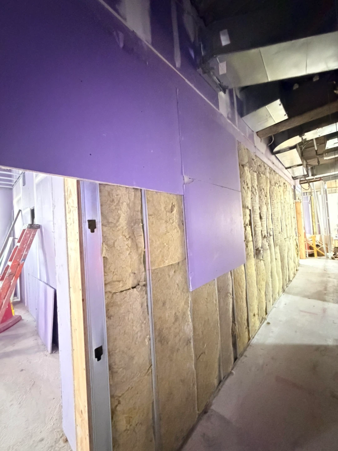 Construction Site Hallway with Drywall and Exposed Utilities - photo 5