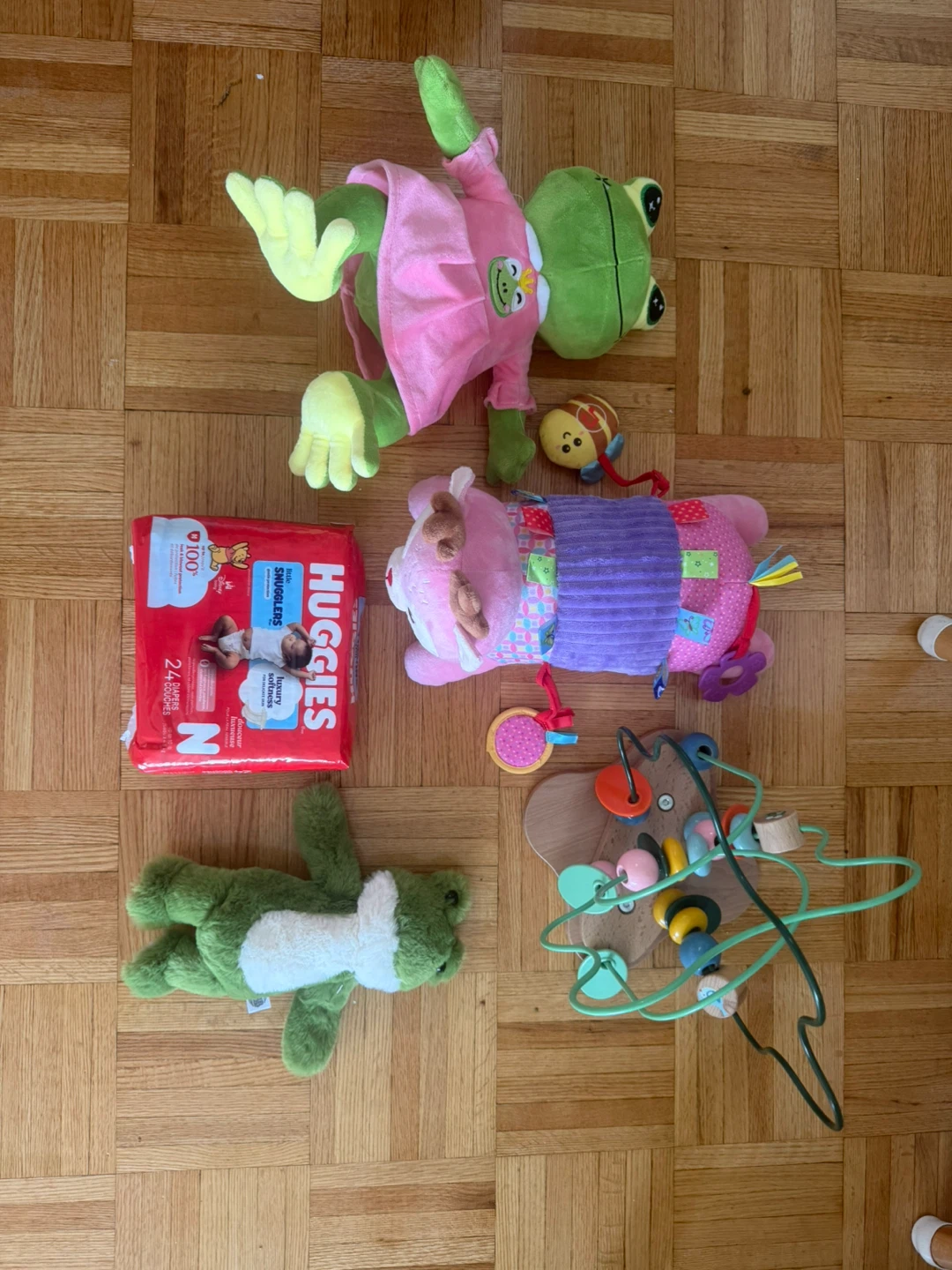 Assorted Baby Toys and Huggies Diapers