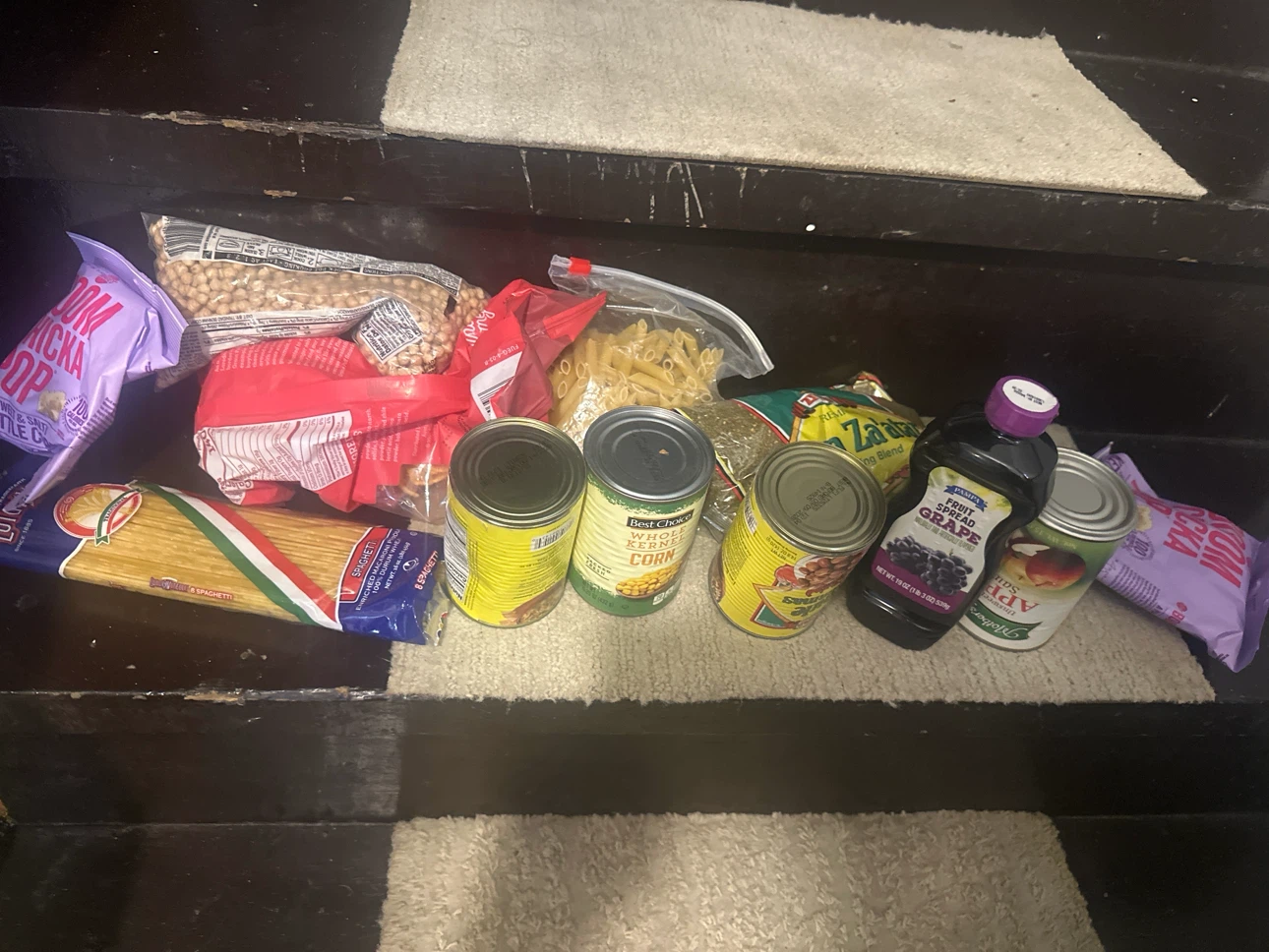 Assorted Groceries: Spaghetti, Canned Goods, and Fruit Spread