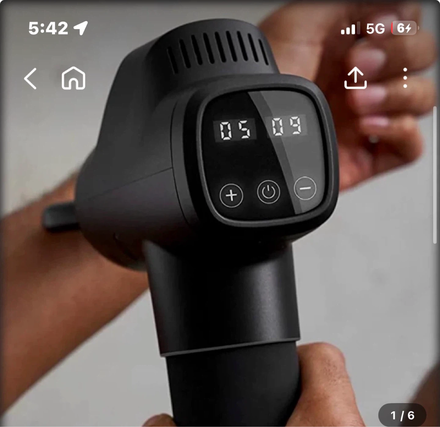 Black handheld massage gun