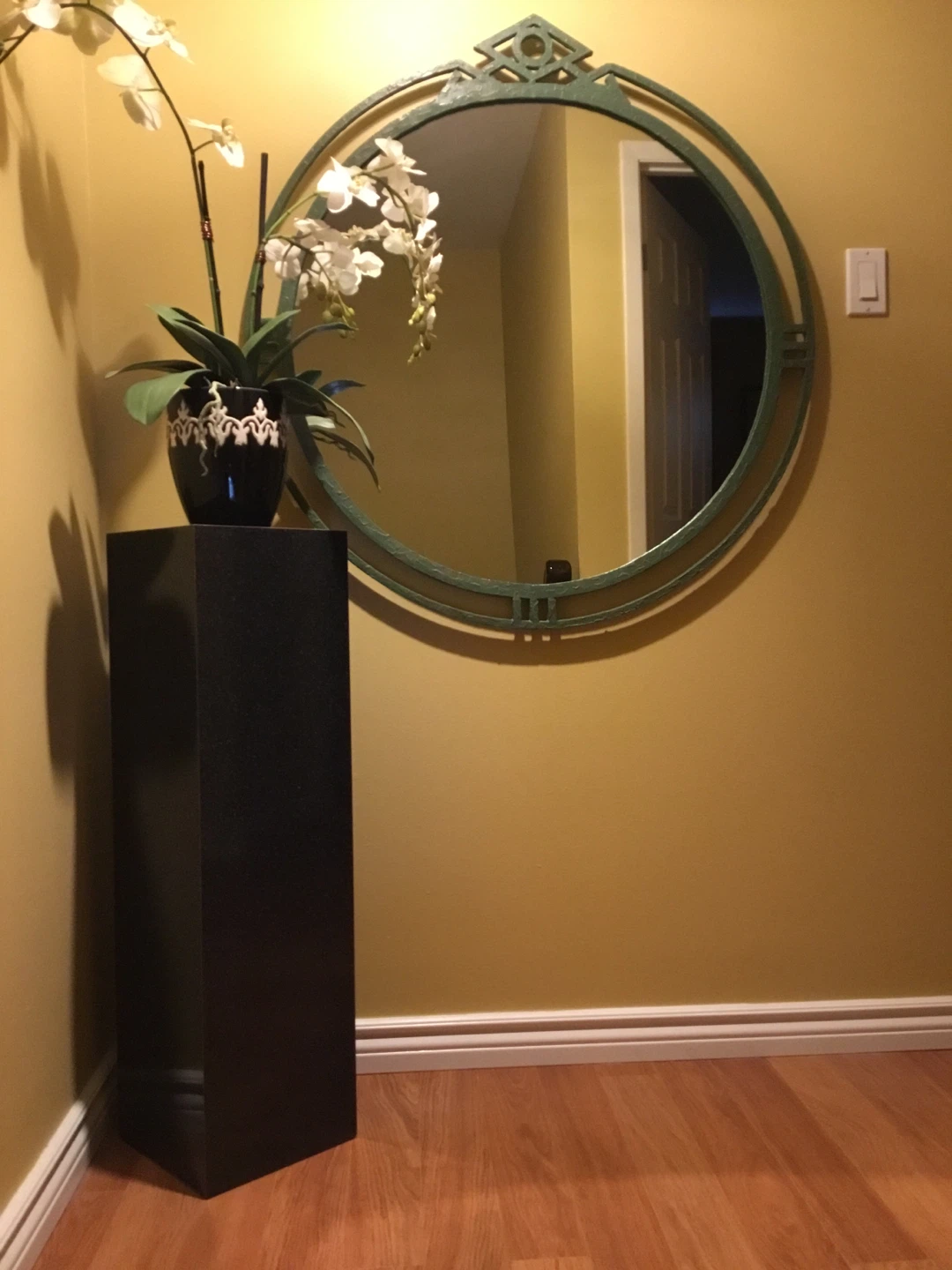 Black Pedestal White Orchid and a green rod iron Mirror 38”