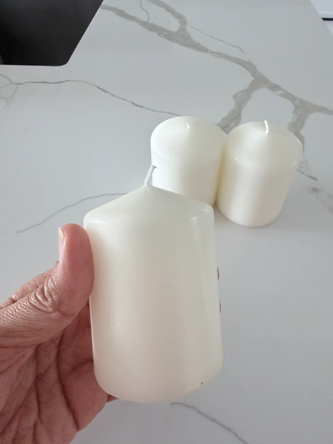 Three white ikea candles