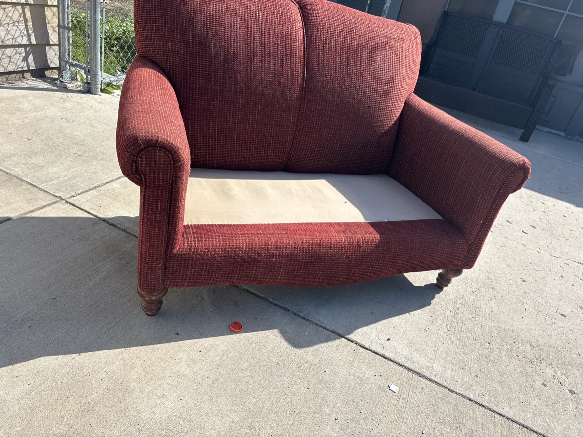 Red Textured Loveseat . Ready for pick up in driveway