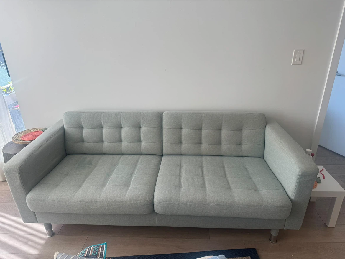 Light grey tufted sofa