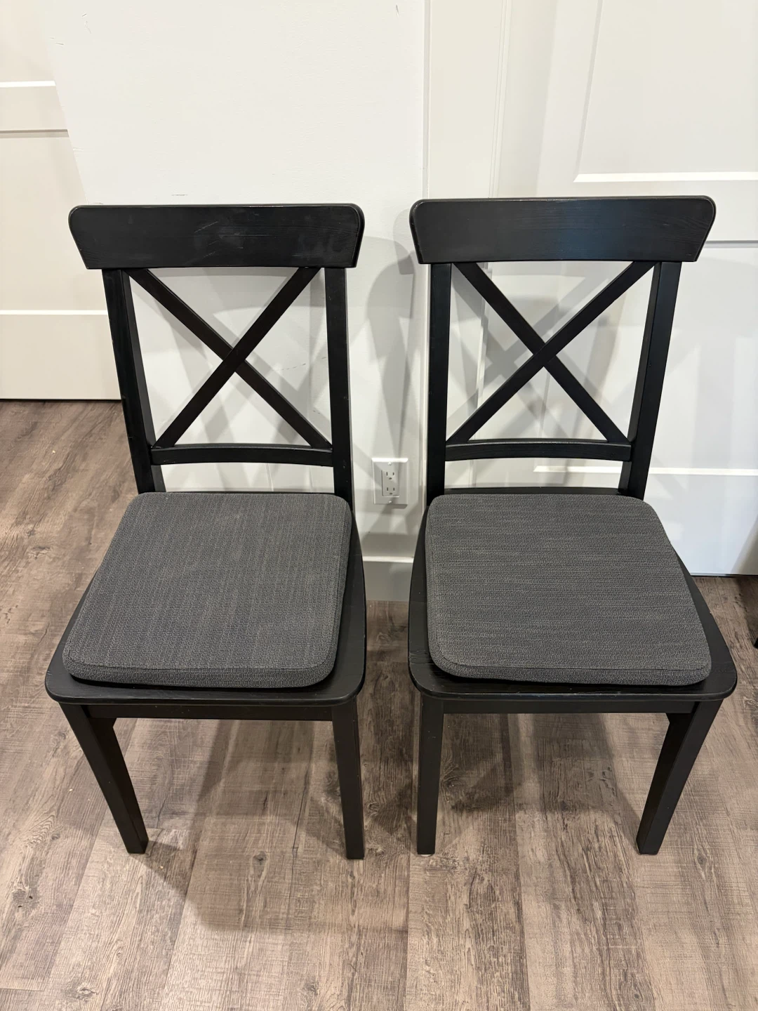 pair of IKEA black chairs wooden