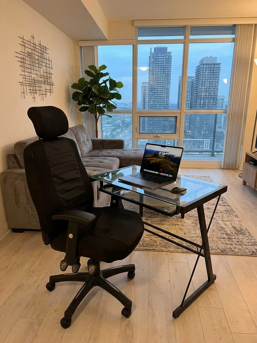 Black Ergonomic Office Chair and Glass Top Desk