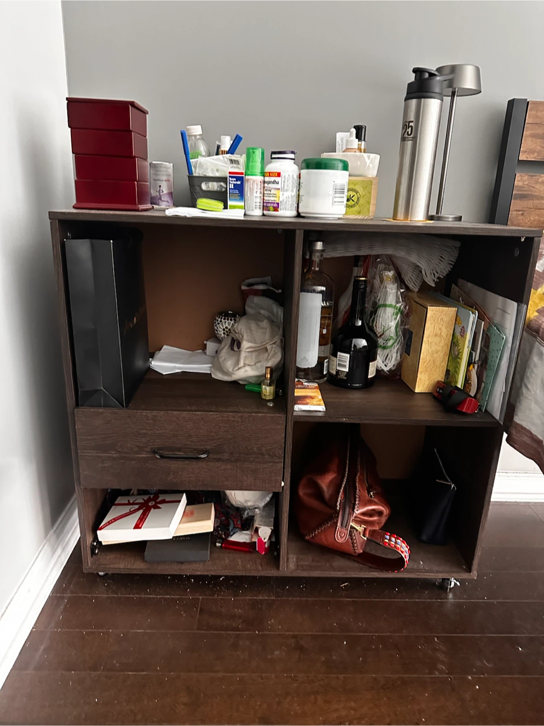 Dark brown wooden storage shelf with one drawer