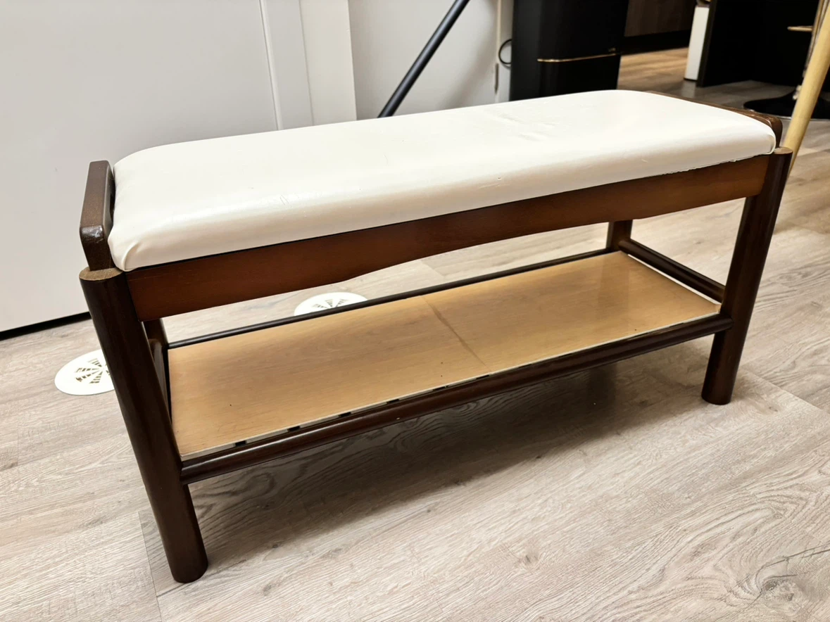 Wooden entryway bench with cream cushion