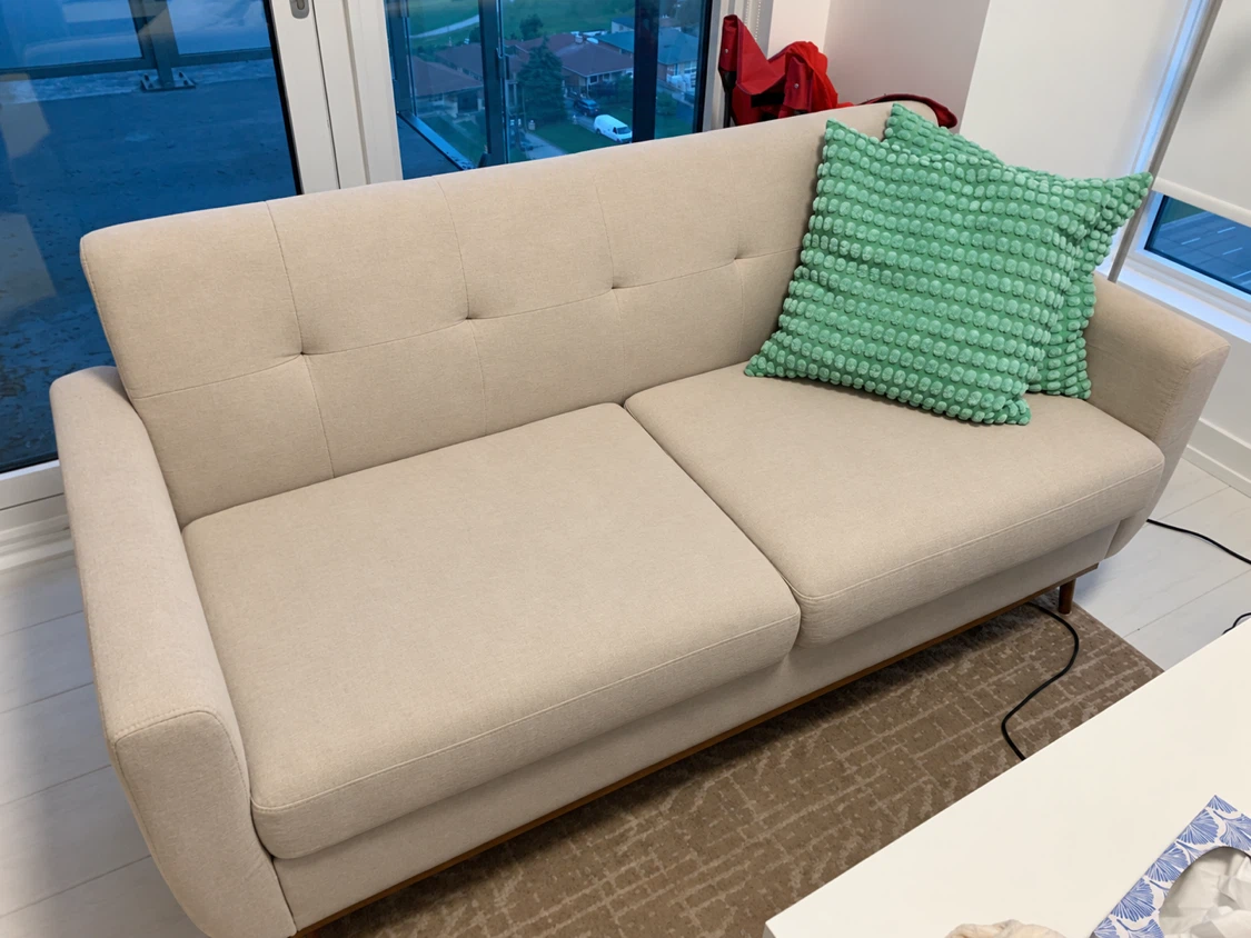 Beige Three Seater Sofa with two cushions
