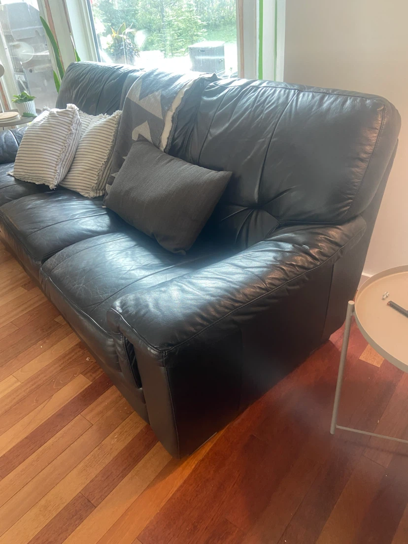Black leather three-seater sofa