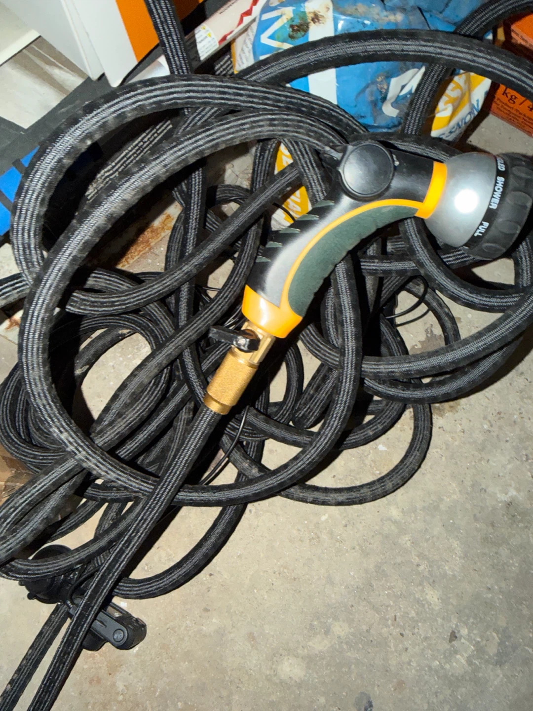 Black expandable garden hose with spray nozzle